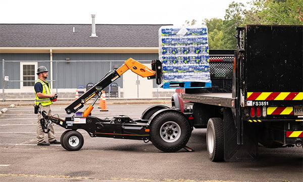 The Equipter Tow-A-Lift moving a pallet of water onto a truck